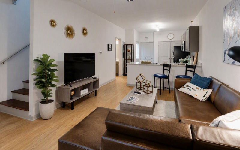 a living room with a couch, tv and coffee table
