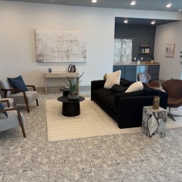 a lounge with a couch, tables and chairs