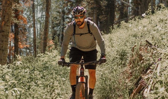 man riding a bike on a trail in the woods