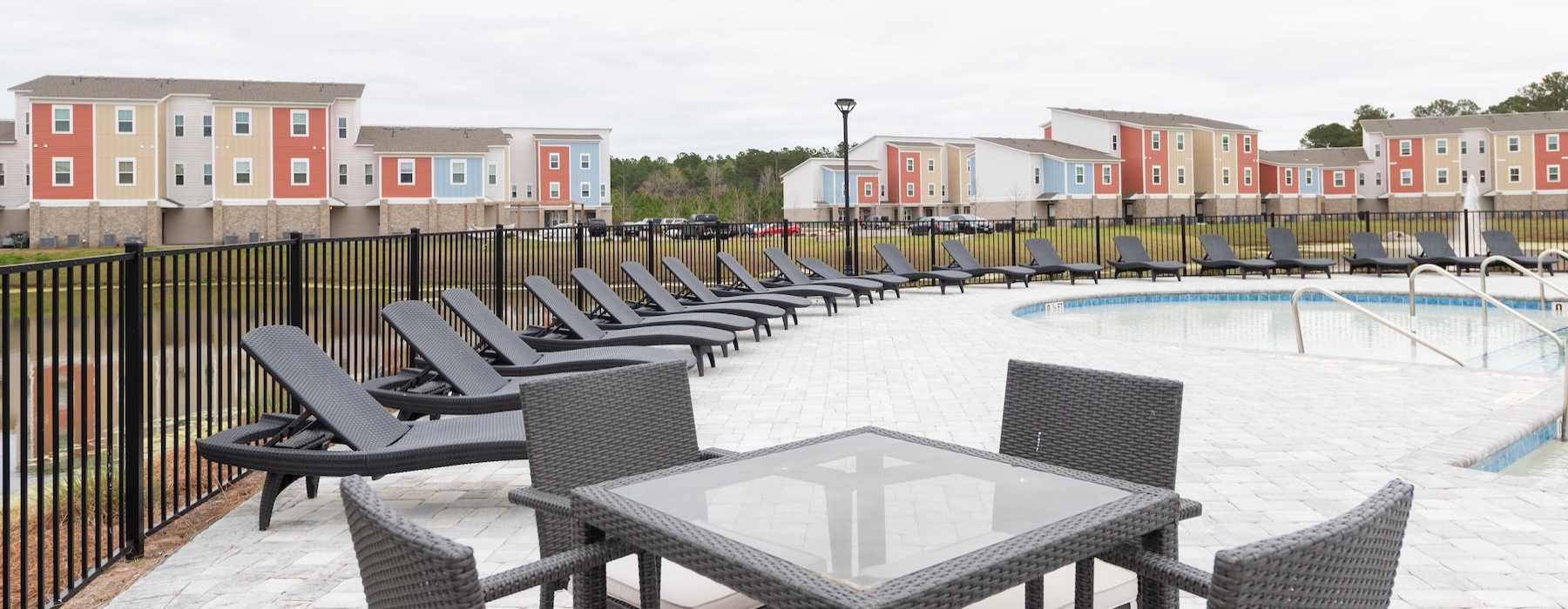 a table and chairs poolside